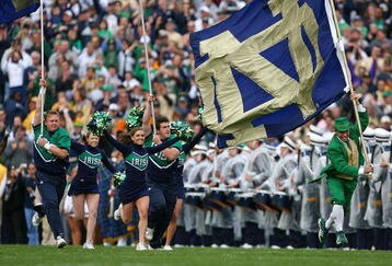 SOUTH BEND, IN - OCTOBER 03: Cheerleaders and the leprechaun mascot of the Notre Dame Fighting Irish run onto the field before a game against the Washington Huskies on October 3, 2009 at Notre Dame Stadium in South Bend, Indiana. Notre Dame defeated Washington 37-30in overtime. (Photo by Jonathan Daniel/Getty Images)
