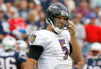 FOXBORO, MA - OCTOBER 4:  Joe Flacco of the Baltimore Ravens pulls grass from his helmet during a game with the New England Patriots at Gillette Stadium on October 4, 2009 in Foxboro, Massachusetts. (Photo by Jim Rogash/Getty Images)