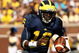 ANN ARBOR, MI - SEPTEMBER 19:  Quarterback Denard Robinson #16 of the Michigan Wolverines carries the ball on a 36 yard touchdown run in the fourth quarter against the Eastern Michigan Eagles at Michigan Stadium on September 19, 2009 in Ann Arbor, Michigan.  Michigan won 45-17.  (Photo by Stephen Dunn/Getty Images)