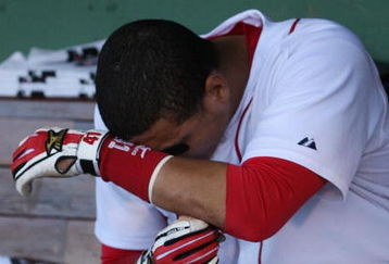 BOSTON - OCTOBER 11:  Cacther Victor Martinez #41 of the Boston Red Sox sits in the dugout after losing to the Los Angeles Angels of Anaheim 7-6 in Game Three of the ALDS during the 2009 MLB Playoffs at Fenway Park on October 11, 2009 in Boston,  Massachusetts. (Photo by Jim Rogash/Getty Images)