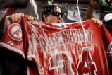 ANAHEIM, CA - SEPTEMBER 28:  Los Angeles Angels of Anaheim players douse the jersey of teammate pitcher Nick Adenhart #34 in beer and champagne as they celebrate after winning the American League West title in the baseball game against the Texas Rangers at Angel Stadium on September 28, 2009 in Anaheim, California. Adenhart was killed in a accident by an alleged drunk driver during the beginning of the season.  (Photo by Kevork Djansezian/Getty Images)