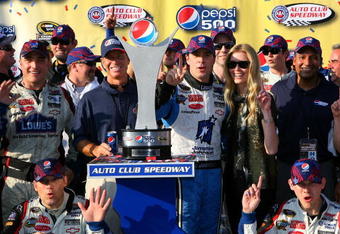 FONTANA, CA - OCTOBER 11:  Jimmie Johnson, driver of the #48 Lowe's Chevrolet, celebrates in victory lane after winning the NASCAR Sprint Cup Series Pepsi 500 at Auto Club Speedway on October 11, 2009 in Fontana, California.  (Photo by Jason Smith/Getty Images for NASCAR)