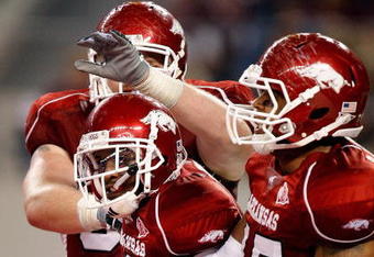 ARLINGTON, TX - OCTOBER 03:  Wide receiver Jarius Wright #4 of the Arkansas Razorbacks celebrates a touchdown pass reception against the Texas A&M Aggies at Dallas Cowboys Stadium on October 3, 2009 in Arlington, Texas.  (Photo by Ronald Martinez/Getty Images)