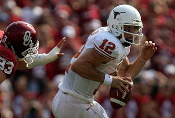 DALLAS - OCTOBER 11:  Quarterback Colt McCoy #12 of the Texas Longhorns runs against Auston English #33 of the Oklahoma Sooners during the Red River Rivalry at the Cotton Bowl on October 11, 2008 in Dallas, Texas.  (Photo by Ronald Martinez/Getty Images)