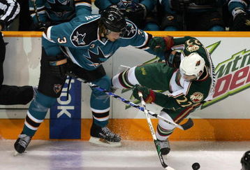 SAN JOSE, CA - OCTOBER 10:  Douglas Murray #3 of the San Jose Sharks and Cal Clutterbuck #22 of the Minnesota Wild go for the puck at HP Pavilion on October 10, 2009 in San Jose, California.  (Photo by Ezra Shaw/Getty Images)