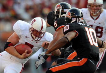 CORVALLIS, OR - OCTOBER 10: Stanford running back Toby Gerhart #7 of the Stanford Cardinals looks for some running room as safety Cameron Collins #5 and safety Lance Mitchell #10 of the Oregon State Beaver close in during the first quarter of the game at Reser Stadium on October 10, 2009 in Corvallis, Oregon. (Photo by Steve Dykes/Getty Images)