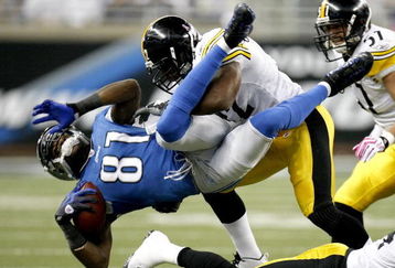 DETROIT , MI - OCTOBER 11:  Calvin Johnson #81 of the Detroit Lions is tackled by James Harrison #92 of the  Pittsburgh Steelers October 11, 2009 at Ford Field in Detroit, Michigan. Johnson was injured on the play.  (Photo by Gregory Shamus/Getty Images)