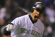 DENVER - OCTOBER 11:  Carlos Gonzalez #5 of the Colorado Rockies reacts after hitting a home run in the bottom of the fourth inning against the Philadelphia Phillies in Game Three of the NLDS during the 2009 MLB Playoffs at Coors Field on October 11, 2009 in Denver, Colorado.  (Photo by Doug Pensinger/ Getty Images)