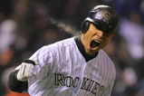 DENVER - OCTOBER 11:  Carlos Gonzalez #5 of the Colorado Rockies reacts after hitting a home run in the bottom of the fourth inning against the Philadelphia Phillies in Game Three of the NLDS during the 2009 MLB Playoffs at Coors Field on October 11, 2009 in Denver, Colorado.  (Photo by Doug Pensinger/ Getty Images)