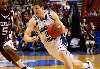 PHILADELPHIA - MARCH 19:  Jimmer Fredette #32 of the Brigham Young Cougars drives against Dash Harris #5 of the Texas A&M Aggies during the first round of the NCAA Division I Men's Basketball Tournament at the Wachovia Center on March 19, 2009 in Philadelphia, Pennsylvania.  (Photo by Jim McIsaac/Getty Images)