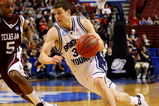 PHILADELPHIA - MARCH 19:  Jimmer Fredette #32 of the Brigham Young Cougars drives against Dash Harris #5 of the Texas A&M Aggies during the first round of the NCAA Division I Men's Basketball Tournament at the Wachovia Center on March 19, 2009 in Philadelphia, Pennsylvania.  (Photo by Jim McIsaac/Getty Images)