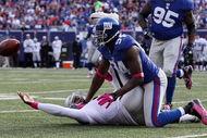EAST RUTHERFORD, NJ - OCTOBER 11:  Mathias Kiwanuka #94 of the New York Giants forces a fumble against JaMarcus Russell #2 of the Oakland Raiders on October 11, 2009 at Giants Stadium in East Rutherford, New Jersey. The Giants defeated the Raiders 44-7.  (Photo by Jim McIsaac/Getty Images)