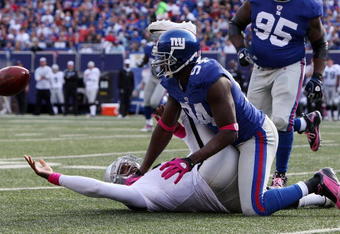 EAST RUTHERFORD, NJ - OCTOBER 11:  Mathias Kiwanuka #94 of the New York Giants forces a fumble against JaMarcus Russell #2 of the Oakland Raiders on October 11, 2009 at Giants Stadium in East Rutherford, New Jersey. The Giants defeated the Raiders 44-7.  (Photo by Jim McIsaac/Getty Images)