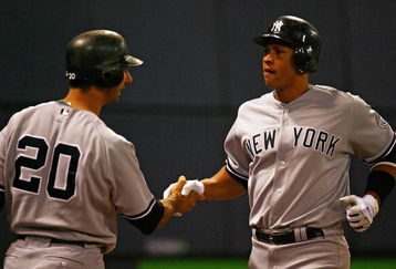 MINNEAPOLIS - OCTOBER 11: Alex Rodriguez #13 of the New York Yankees shakes hands with Jorge Posada #20 after hitting a solo home run in the 7th inning against the Minnesota Twins in Game Three of the ALDS during the 2009 MLB Playoffs at the Hubert H. Humphrey Metrodome on October 11, 2009 in Minneapolis, Minnesota. (Photo by Jonathan Daniel/Getty Images)