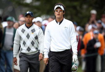SAN FRANCISCO - OCTOBER 10: Ryo Ishikawa of Japan and the International Team walks from the 6th tee followed by Tiger Woods of the USA Team during the Day Three Afternoon Fourball Matches in The Presidents Cup at Harding Park Golf Course on October 10, 2009 in San Francisco, California  (Photo by David Cannon/Getty Images)