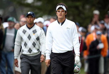 SAN FRANCISCO - OCTOBER 10: Ryo Ishikawa of Japan and the International Team walks from the 6th tee followed by Tiger Woods of the USA Team during the Day Three Afternoon Fourball Matches in The Presidents Cup at Harding Park Golf Course on October 10, 2009 in San Francisco, California  (Photo by David Cannon/Getty Images)