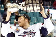 RIMOUSKI, QC - MAY 24:   Taylor Hall #4 of the Windsor Spitfires raises the Memorial Cup after defeating the Kelowna Rockets during the 2009 Mastercard Memorial Cup Final at the Rimouski Colisee on May 24, 2009 in Rimouski, Quebec, Canada.  The Spitfires defeated the Rockets 4-1 winning the 2009 Memorial Cup.  (Photo by Richard Wolowicz/Getty Images)