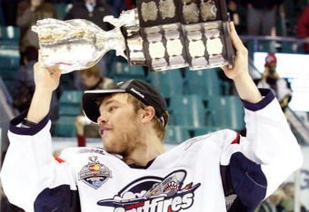 RIMOUSKI, QC - MAY 24:   Taylor Hall #4 of the Windsor Spitfires raises the Memorial Cup after defeating the Kelowna Rockets during the 2009 Mastercard Memorial Cup Final at the Rimouski Colisee on May 24, 2009 in Rimouski, Quebec, Canada.  The Spitfires defeated the Rockets 4-1 winning the 2009 Memorial Cup.  (Photo by Richard Wolowicz/Getty Images)