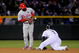 DENVER - OCTOBER 11:  Carlos Gonzalez #5 of the Colorado Rockies steals second base as Jimmy Rollins #11 of the Philadelphia Phillies takes the throw in the ninth inning during Game 3 of their National League Division series at Coors Field on October 11, 2009 in Denver, Colorado. The Phillies defeated the Rockies 6-5 in game 3 to take 2-1 lead in the series.  (Photo by Doug Pensinger/Getty Images)