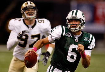 NEW ORLEANS - OCTOBER 04:  Quarterback Mark Sanchez #6 of the New York Jets scrambles away from Jeff Charleston #97 of the New Orleans Saints at the Louisana Superdome on October 4, 2009 in New Orleans, Louisiana.  (Photo by Chris Graythen/Getty Images)