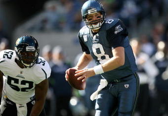 SEATTLE - OCTOBER 11:  Quarterback Matt Hasselbeck #8 of the Seattle Seahawks scrambles against linebacker Daryl Smith #52 of the Jacksonville Jaguars on October 11, 2009 at Qwest Field in Seattle, Washington. The Seahawks defeated the Jaguars 41-0. (Photo by Otto Greule Jr/Getty Images)