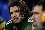 GREEN BAY, WI - JANUARY 9:  Tackle Mark Tauscher #65 of the Green Bay Packers watches from the sidelines as his team is eliminated from the playoffs by the Minnesota Vikings in the NFC wild-card game at Lambeau Field January 9, 2005 in Green Bay, Wisconsin. The Vikings defeated the Packers 31-17.  (Photo by Jonathan Daniel/Getty Images)