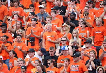 STILLWATER, OK - SEPTEMBER 05:  Fans of the Oklahoma State Cowboys cheers during the college football game against the Georgia Bulldogs at Boone Pickens Stadium on September 5, 2009 in Stillwater, Oklahoma.  The Cowboys defeated the Bulldogs 24-10.  (Photo by Christian Petersen/Getty Images)