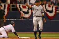 MINNEAPOLIS - OCTOBER 11: Alex Rodriguez #13 of the New York Yankees points to teammate Jorge Posada after he tagged out Nick Punto #8 of the Minnesota Twins in Game Three of the ALDS during the 2009 MLB Playoffs at the Hubert H. Humphrey Metrodome on October 11, 2009 in Minneapolis, Minnesota. (Photo by Jonathan Daniel/Getty Images)