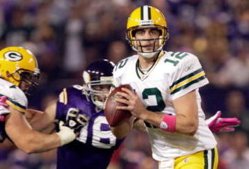 MINNEAPOLIS - OCTOBER 05:  Quarterback Aaron Rodgers #12 of the Green Bay Packers is chased by Brian Robinson #96 of the Minnesota Vikings during the Monday Night Football game on October 5, 2009 at Hubert H. Humphrey Metrodome in Minneapolis, Minnesota.  (Photo by Jamie Squire/Getty Images)
