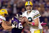 MINNEAPOLIS - OCTOBER 05:  Quarterback Aaron Rodgers #12 of the Green Bay Packers is chased by Brian Robinson #96 of the Minnesota Vikings during the Monday Night Football game on October 5, 2009 at Hubert H. Humphrey Metrodome in Minneapolis, Minnesota.  (Photo by Jamie Squire/Getty Images)