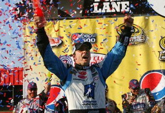 FONTANA, CA - OCTOBER 11:  Jimmie Johnson, driver of the #48 Lowe's Chevrolet, celebrates in victory lane after winning the NASCAR Sprint Cup Series Pepsi 500 at Auto Club Speedway on October 11, 2009 in Fontana, California.  (Photo by Jason Smith/Getty Images for NASCAR)