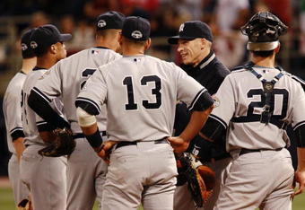 MINNEAPOLIS, MN - OCTOBER 11: Manager Joe Girardi of the New York Yankees speaks with players during a pitching change against the Minnesota Twins in Game Three of the ALDS during the 2009 MLB Playoffs at the Hubert H. Humphrey Metrodome on October 11, 2009 in Minneapolis, Minnesota. (Photo by Genevieve Ross/Getty Images)