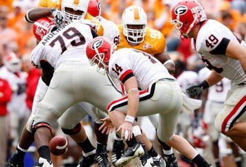 KNOXVILLE, TN - OCTOBER 10: Joe Cox #14 of the Georgia Bulldogs funmbles the ball during the SEC game against the Tennessee Volunteers at Neyland Stadium on October 10, 2009 in Knoxville, Tennessee. (Photo by Andy Lyons/Getty Images)