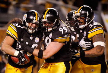 PITTSBURGH - JANUARY 18:  Safety Troy Polamalu #43 of the Pittsburgh Steelers celebrates his touchdown with defensive end Brett Keisel #99, safety Tyrone Carter #23 and linebacker LaMarr Woodley #56 against the Baltimore Ravens during the fourth quarter of the AFC championship game on January 18, 2009 at Heinz Field in Pittsburgh, Pennsylvania.  (Photo by Gregory Shamus/Getty Images)