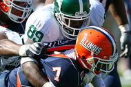 CHAMPAIGN, IL - OCTOBER 10: Juice Williams #7 of the Illinois Fighting Illini is sacked by Colin Neely #89 of the Michigan State Spartans on October 10, 2009 at Memorial Stadium at the University of Illinois in Champaign, Illinois. Michigan State defeated Illinois 24-14. (Photo by Jonathan Daniel/Getty Images)