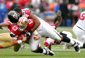 SAN FRANCISCO - OCTOBER 11:  Shaun Hill #13 ofthe San Francisco 49ers is tackled by Trey Lewis #97 of the Atlanta Falcons at Candlestick Park on October 11, 2009 in San Francisco, California.  (Photo by Ezra Shaw/Getty Images)