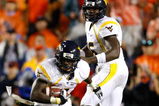 AUBURN, AL - SEPTEMBER 19:  Quarterback Jarrett Brown #16 and Noel Devine #7 of the West Virginia Mountaineers against the Auburn Tigers at Jordan-Hare Stadium on September 19, 2009 in Auburn, Alabama.  (Photo by Kevin C. Cox/Getty Images)