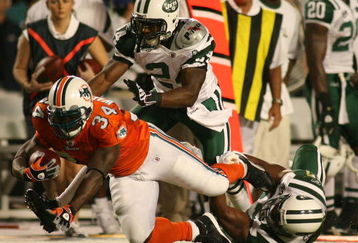 MIAMI - OCTOBER 12:  Running back Rickey Williams #34 of the Miami Dolphins is brought down b corner back Darrelle Revis #24 and linebacker Jamaal Westerman #55 of the New York Jets at Land Shark Stadium on October 12, 2009 in Miami, Florida.  (Photo by Marc Serota/Getty Images)