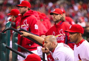 ST. LOUIS, MO - OCTOBER 10:  Albert Pujols #5 of the St. Louis Cardinals and teammates look on from the dugout after the Los Angeles win the NLDS  5-1 during the 2009 MLB Playoffs at Busch Stadium on October 10, 2009 in St. Louis, Missouri. (Photo by Dilip Vishwanat/Getty Images)