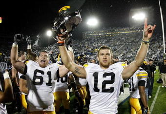 STATE COLLEGE, PA - SEPTEMBER 26:  Ricky Stanzi #12 of the Iowa Hawkeyes celebrates a 21-10 victory over the Penn State Nittnay Lions with Travis Meade #61 on September 26, 2009 at Beaver Stadium in State College, Pennsylvania.  (Photo by Gregory Shamus/Getty Images)