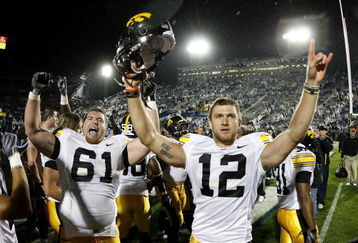 STATE COLLEGE, PA - SEPTEMBER 26:  Ricky Stanzi #12 of the Iowa Hawkeyes celebrates a 21-10 victory over the Penn State Nittnay Lions with Travis Meade #61 on September 26, 2009 at Beaver Stadium in State College, Pennsylvania.  (Photo by Gregory Shamus/Getty Images)