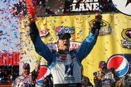 FONTANA, CA - OCTOBER 11:  Jimmie Johnson, driver of the #48 Lowe's Chevrolet, celebrates in victory lane after winning the NASCAR Sprint Cup Series Pepsi 500 at Auto Club Speedway on October 11, 2009 in Fontana, California.  (Photo by Jason Smith/Getty Images for NASCAR)