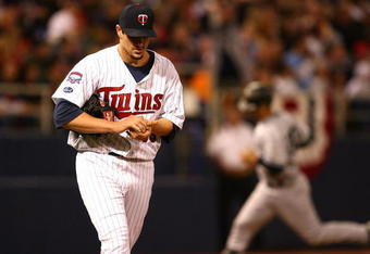 MINNEAPOLIS - OCTOBER 11: Carl Pavano #48 of the Minnesota Twins reacts as Jorge Posada #20 of the New York Yankees runs the bases after hitting a solo home run in the 7th inning in Game Three of the ALDS during the 2009 MLB Playoffs at the Hubert H. Humphrey Metrodome on October 11, 2009 in Minneapolis, Minnesota. (Photo by Jonathan Daniel/Getty Images)