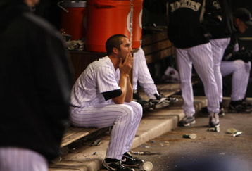 DENVER - OCTOBER 12:  Huston Street #16 of the Colorado Rockies sits dejected in the dugout after the loss against the Philadelphia Phillies in Game Four of the NLDS during the 2009 MLB Playoffs at Coors Field on October 12, 2009 in Denver, Colorado. (Photo by Jed Jacobsohn/Getty Images)