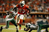 MIAMI - OCTOBER 12:  Running back Ronnie Brown #23 of the Miami Dolphins jumps between linebacker Bryan Thomas #99 and cornerback Darrelle Revis #24 of the New York Jets at Land Shark Stadium on October 12, 2009 in Miami, Florida. The Dolphins defeated the Jets 31-27.  (Photo by Doug Benc/Getty Images)