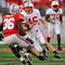 COLUMBUS, OH - OCTOBER 10:  Quarterback Scott Tolzien #16 of the Wisconsin Badgers looks for running room as Brian Rolle #36 of the Ohio State Buckeyes closes in for the tackle at Ohio Stadium on October 10, 2009 in Columbus, Ohio.  (Photo by Jamie Sabau/Getty Images)