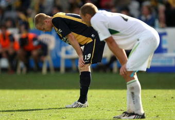 GOSFORD, AUSTRALIA - OCTOBER 11:  Matthew Simon of the Mariners and Rostyn Griffiths of the Fury show their frustration after thier draw in the round 10 A-League match between the Central Coast Mariners and the North Queensland Fury at Bluetongue Stadium on October 11, 2009 in Gosford, Australia.  (Photo by Mark Kolbe/Getty Images)