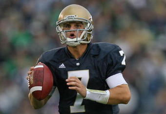SOUTH BEND, IN - OCTOBER 03: Jimmy Clausen #7 of the Notre Dame Fighting Irish looks for a receiver against the Washington Huskies on October 3, 2009 at Notre Dame Stadium in South Bend, Indiana. Notre Dame defeated Washington 37-30 in overtime. (Photo by Jonathan Daniel/Getty Images)