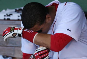 BOSTON - OCTOBER 11:  Cacther Victor Martinez #41 of the Boston Red Sox sits in the dugout after losing to the Los Angeles Angels of Anaheim 7-6 in Game Three of the ALDS during the 2009 MLB Playoffs at Fenway Park on October 11, 2009 in Boston,  Massachusetts. (Photo by Jim Rogash/Getty Images)
