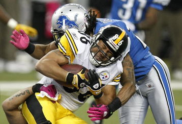 DETROIT , MI - OCTOBER 11:  Hines Ward #86 of the Pittsburgh Steelers is tackled after a fourth quarter catch by Louis Delmas #26 of the Detroit Lions on October 11, 2009 at Ford Field in Detroit, Michigan. Pittsburgh won the game 28-20.(Photo by Gregory Shamus/Getty Images)